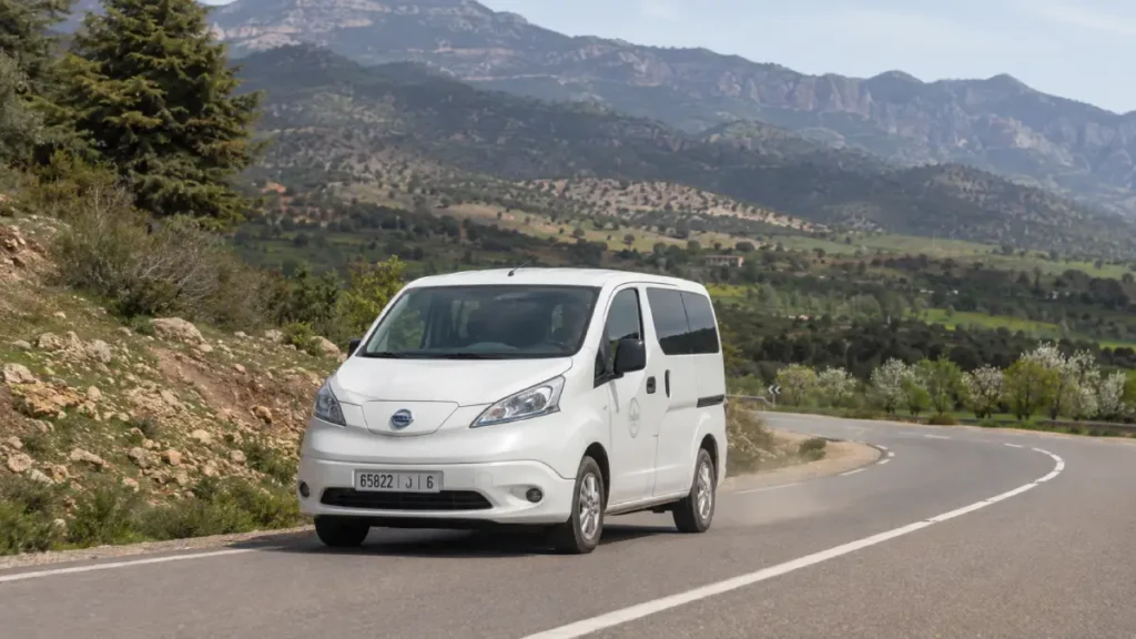 White Nissan NV200 grand taxi driving through the Middle Atlas near Imouzzer Kandar, the journey behind this Beef Tagine Recipe