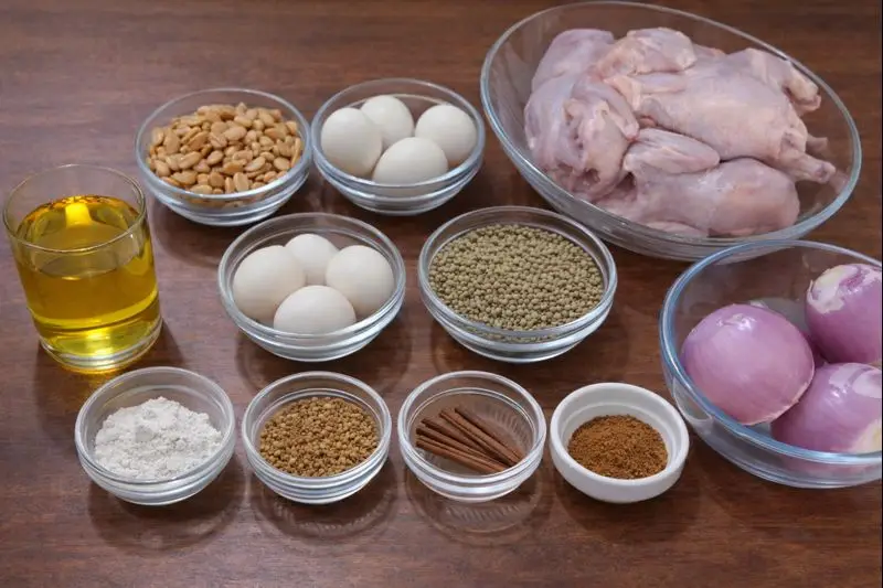 Rfissa ingredients on a wooden table, including coquelet chickens, spices, onions, lentils, and eggs — prepared for a typical Moroccan meal.