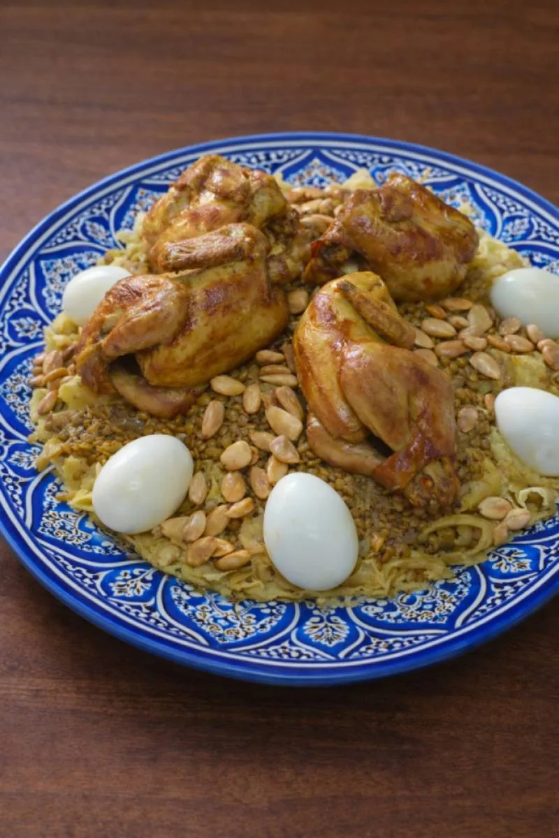 Typical Moroccan meal: Rfissa served with chicken, lentils, and eggs.