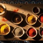 Featured image showing Moroccan spices arranged in clay bowls on a handmade Moroccan kitchen table