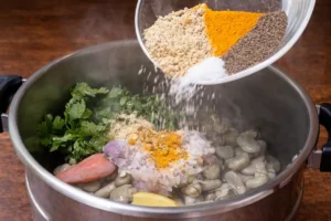 Spices, onion, cilantro, and lemon being added to fava beans for a Vegetarian Tagine Recipe